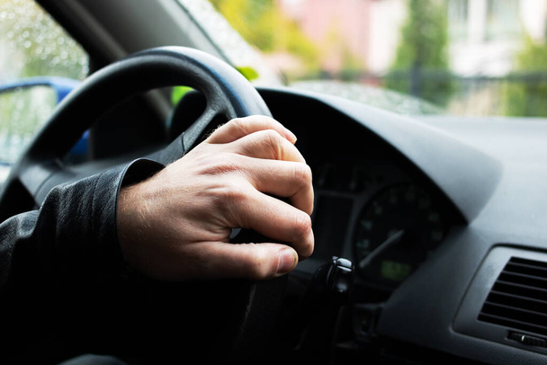 Hand on the steering wheel of a car close up - Valokuva, kuva