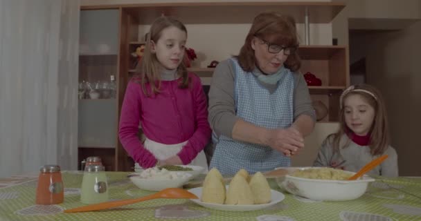 Torunları genç büyükannesine Arancini pişirmesinde yardım ediyor, tipik Sicilya yemekleri. - Video, Çekim