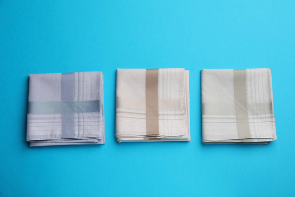 Stylish handkerchiefs on light blue background, flat lay - Valokuva, kuva