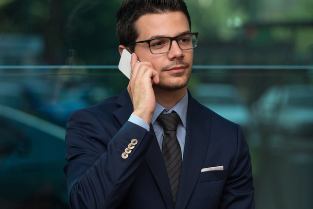 Businessman Talking On Telephone In Office - Valokuva, kuva