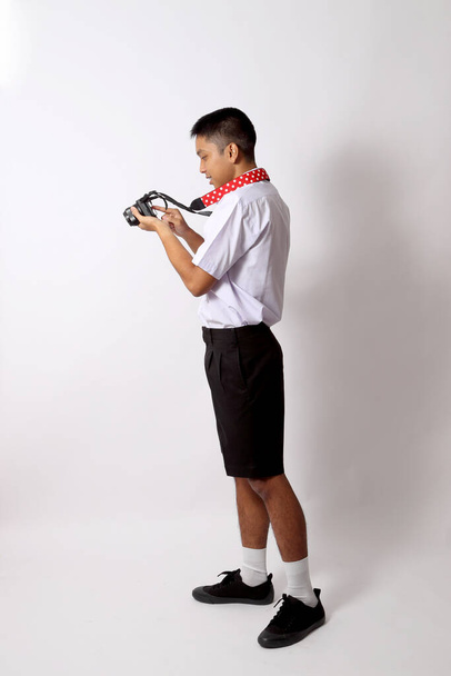 O jovem estudante tailandês no fundo branco. - Foto, Imagem