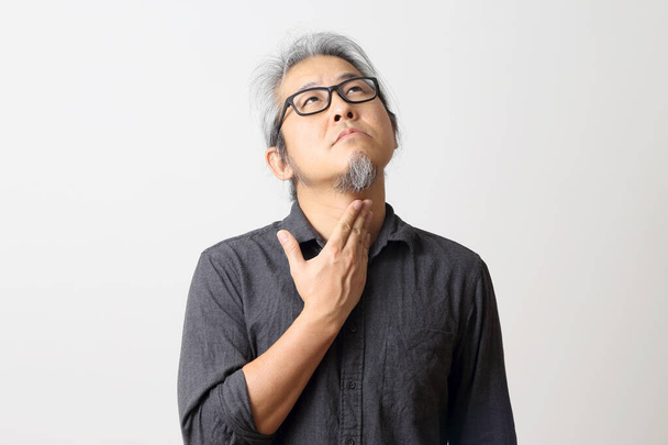 The adult Asian man on the white background. - Photo, Image