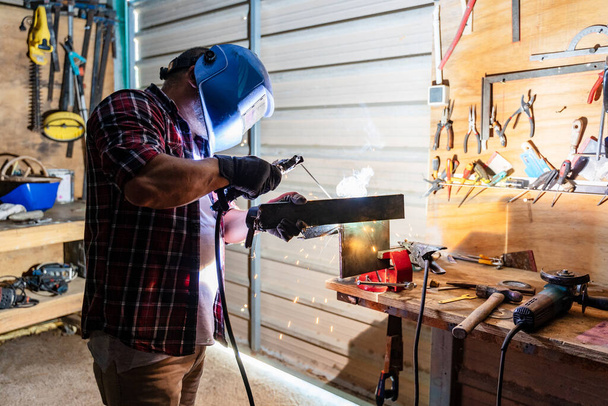 A Caucasian repairman in a workshop - 写真・画像