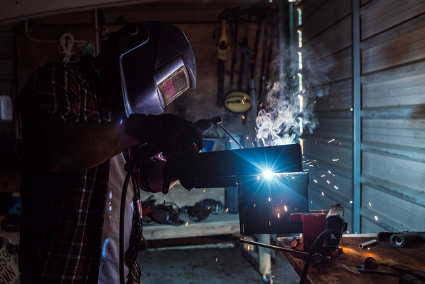 A Caucasian repairman in a workshop - Photo, image