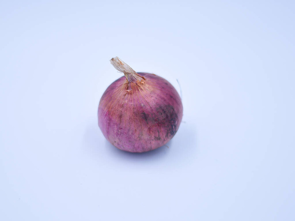 A closeup of the onion isolated on light bluish background. - Φωτογραφία, εικόνα