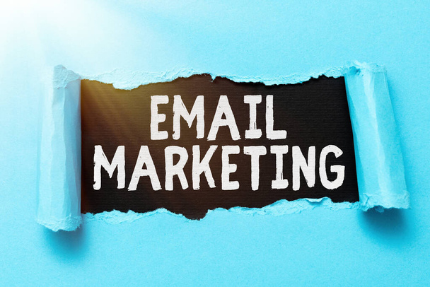 Inspiration showing sign Email Marketing. Business concept act of sending a commercial message to a group of showing Tear on sheet reveals background behind the front side - Photo, Image