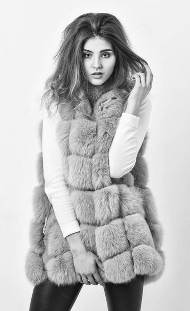 Prevent winter hair damage. Woman makeup face touch hair volume hairstyle. Winter hair care tips you should follow. Hair care concept. Girl fur coat posing with hairstyle on white background - Foto, imagen
