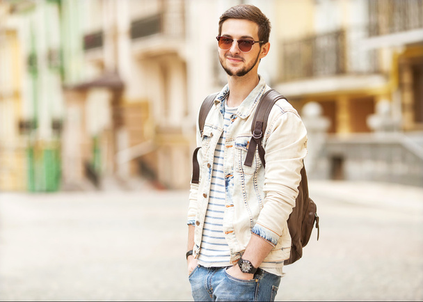 Portrait of attractive man with casual clothes walk in Europe - 写真・画像