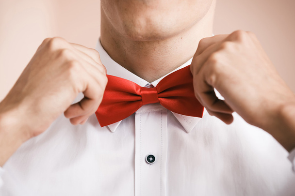 Man puts on red bow tie. Close up. Shallow depth of field. - Fotoğraf, Görsel