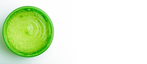 Cosmetic gel in a jar on a white banner background. Green transparent gel with texture and bubbles isolate - Photo, Image