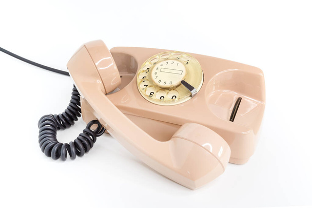 Vintage telephone. Pink old telephone isolated on white background. - Photo, Image
