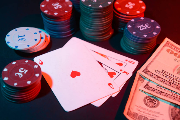 Poker žetony a hrací karty na tmavém pozadí - Fotografie, Obrázek