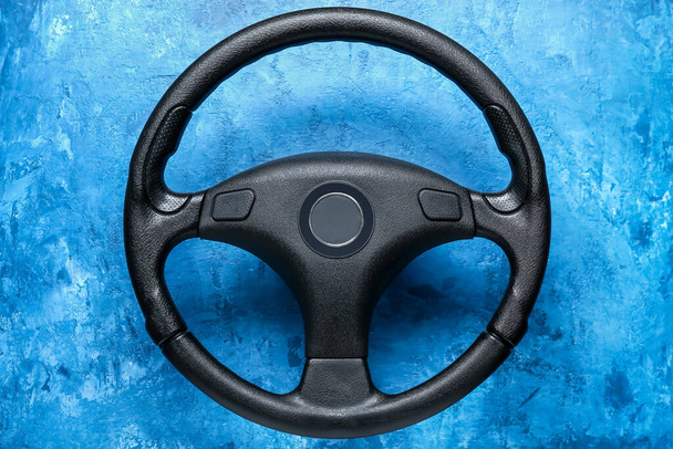 Modern steering wheel on blue background - Photo, Image