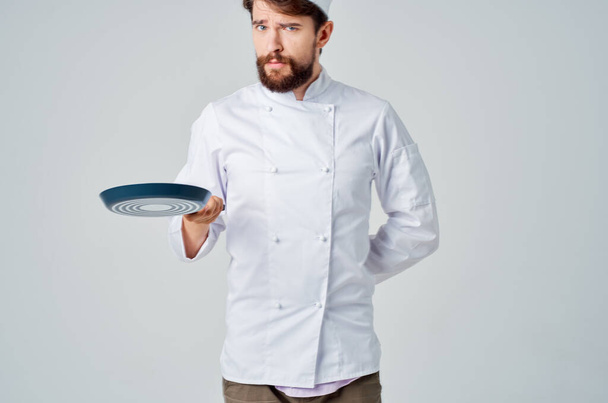 bearded man chef with a frying pan in hand isolated background - Photo, Image
