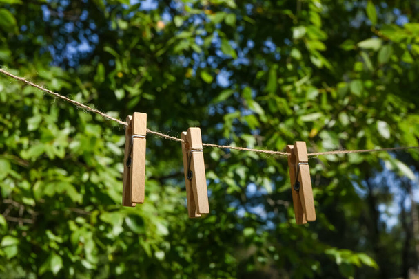 Clothespins hanging on laundry line outdoors - Photo, Image