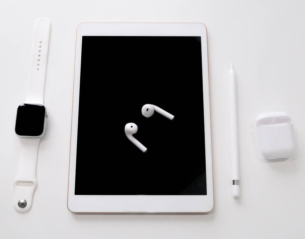 white tablet with pencil wireless headphones with case smart watch on white table - Photo, Image
