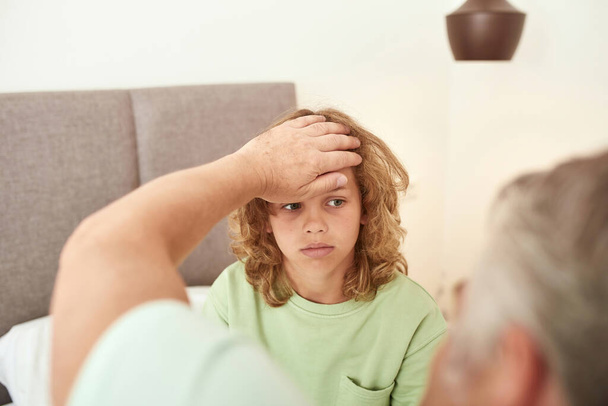 Caring parent worry about sick teen son - Foto, immagini