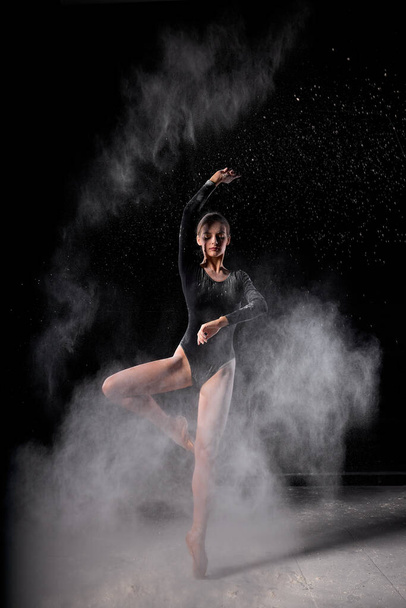 young slim caucasian ballet dancer women wearing black bodysuit, sensually poses - Фото, изображение
