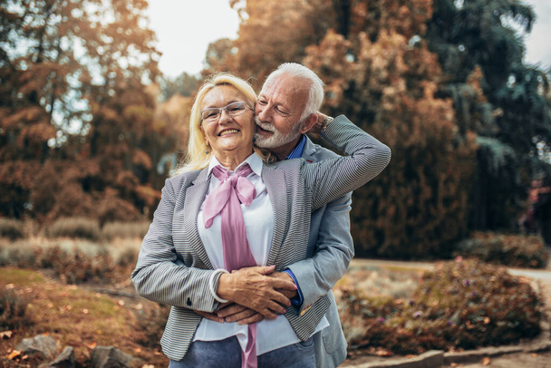 Happy senior couple in autumn park - Photo, Image