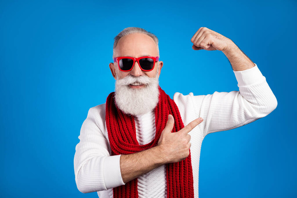 Photo of strong funny mature man dressed white pullover red glasses pointing finger arm muscle isolated blue color background - Photo, Image
