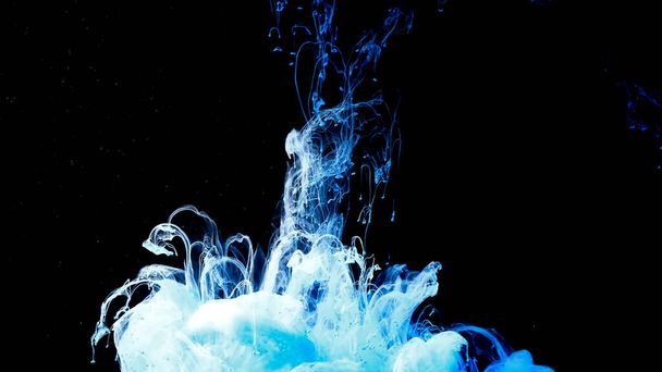 Drops of blue ink in water. Cosmic star background. Awesome abstract background. Beautiful wallpaper for your desktop. Blue and white cloud of ink on a black background. - 写真・画像