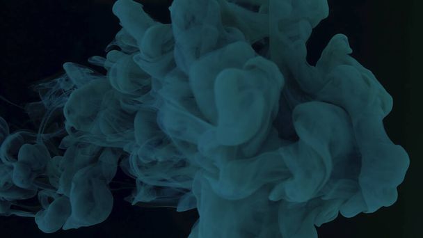 Beautiful abstract background. Blue-green watercolor paints in water on a black background. Chic wallpaper for your desktop. Creative hyptonic background. Blue-green cloud of ink on a black background. - 写真・画像