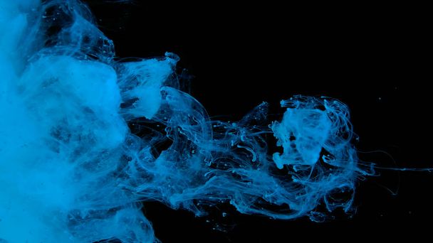 Awesome abstract background. Beautiful wallpaper for your desktop. Blue cloud of ink on a black background. Drops of blue ink in water. Blue watercolor paints in water on a black background. - Фото, изображение