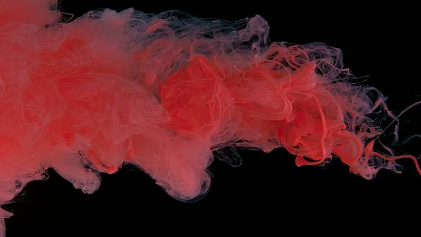 Awesome abstract background. Beautiful wallpaper for your desktop. Pink cloud of ink on a black background. Drops of pink ink in water. Pink watercolor paints in water on a black background. - Foto, Bild