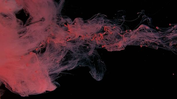 Pink cloud of ink on a black background. Drops of pink ink in water. Pink watercolor paints in water on a black background. Awesome abstract background. Beautiful wallpaper for your desktop. - Photo, image