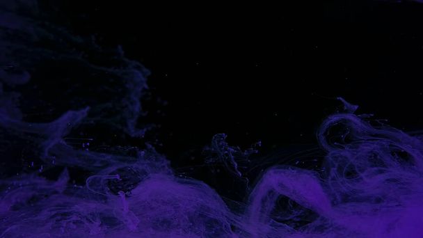 Awesome abstract background. Beautiful wallpaper for your desktop. Violet cloud of ink on a black background. Drops of purple ink in water. Purple watercolor paints in water on a black background. - Valokuva, kuva