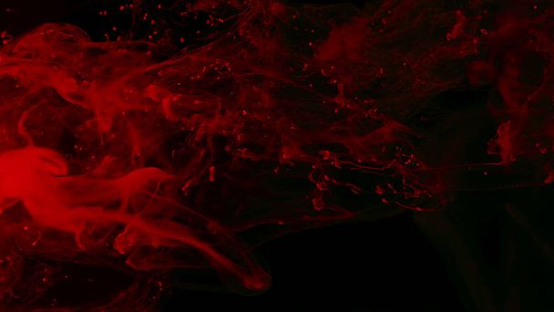 Awesome abstract background. Drops of red ink in water. Cosmic star background. Red watercolor paints in water on a black background. Beautiful wallpaper for your desktop. Red cloud of ink. - Fotó, kép