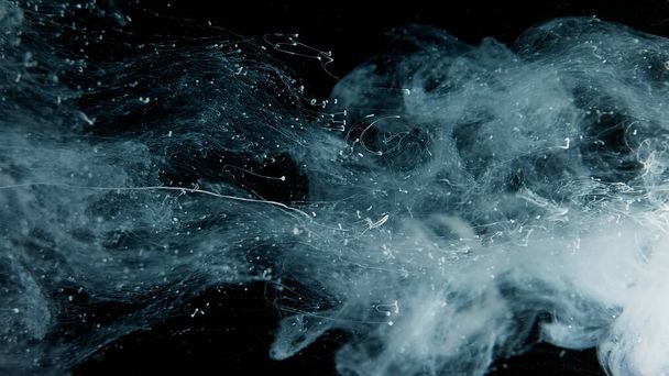 Beautiful wallpaper for your desktop. White cloud of ink on a black background. Drops of white ink in water. Cosmic star background. Awesome abstract background. - 写真・画像