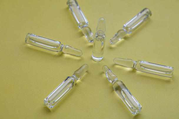 Glass medical ampoules for injection.  Ampoules with vaccine, medicine, collagen, vitamins, clear liquid - Fotó, kép
