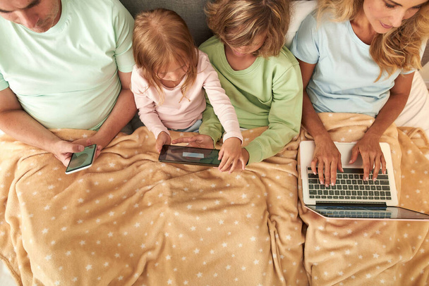 Top view of family with kids relax with devices - Zdjęcie, obraz