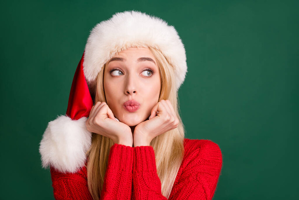 Portrait of attractive funny dreamy blond girl sending air kiss winter copy space isolated over green color background - Foto, afbeelding
