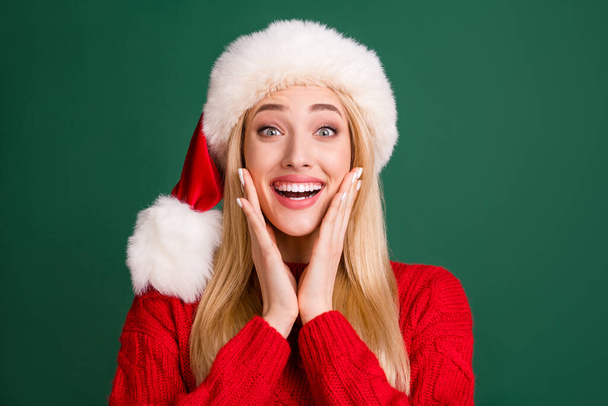 Photo of cheerful young positive happy woman hold hands face cheeks xmas isolated on green color background - Fotografie, Obrázek