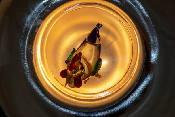 Ein kleiner, spielzeugfarbener Glashahn - Foto, Bild
