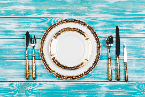 Beautiful table setting on blue wooden background - Фото, зображення