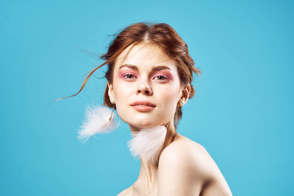 pretty woman fluffy earrings bright makeup blue background fashion - Photo, Image