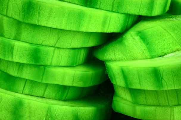 food background detail green zucchini sliced into wheels - Fotoğraf, Görsel