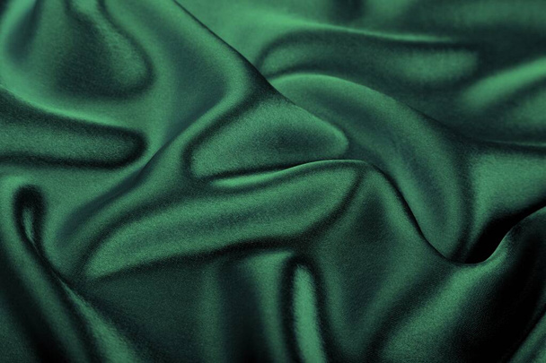 Texture, the background of beautiful emerald green soft silk fabric. - Foto, Imagen