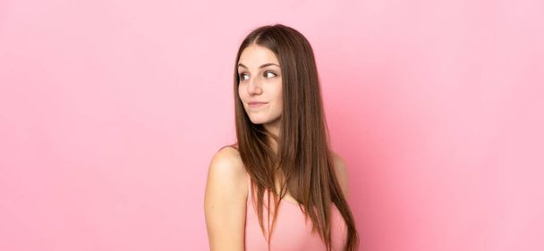 Young caucasian woman isolated on pink background . Portrait - Фото, зображення