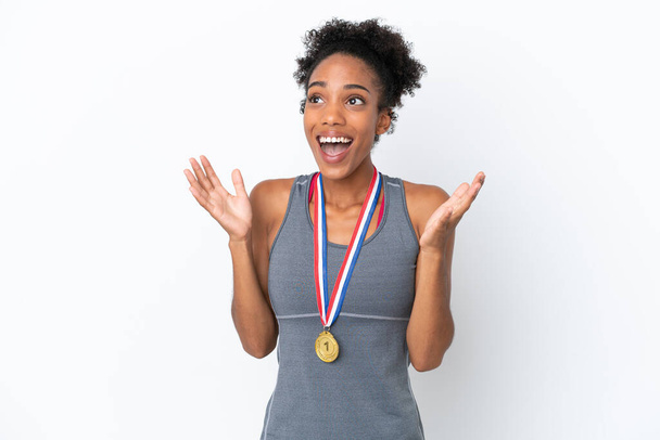 Young African American woman with medals isolated on white background with surprise facial expression - Photo, Image