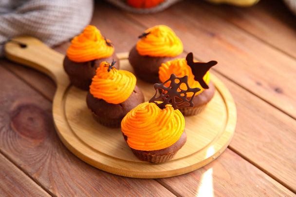 Halloween čokoládové cupcakes s výzdobou na dřevěném pozadí - Fotografie, Obrázek