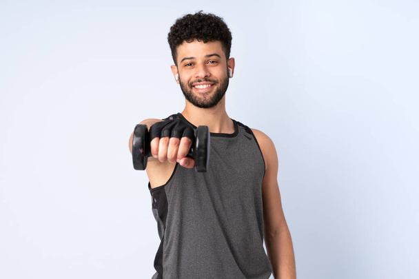 Young Moroccan man isolated on blue background making weightlifting - Foto, Bild