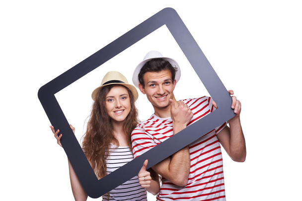 Happy couple looking through tablet frame - Фото, изображение