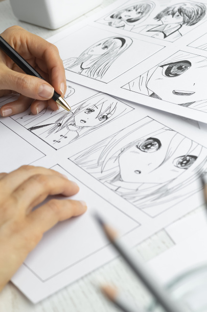 The artist draws anime comics on paper. Storyboard for the cartoon. The illustrator creates sketches for the book. - Photo, Image