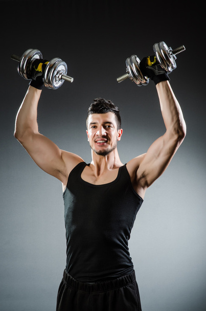 Muscular ripped bodybuilder with dumbbells - Foto, imagen