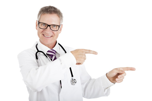 Friendly smiling doctor pointing to the right - Foto, imagen