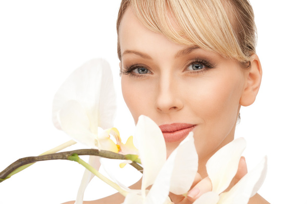 Beautiful woman with orchid flower - Photo, image